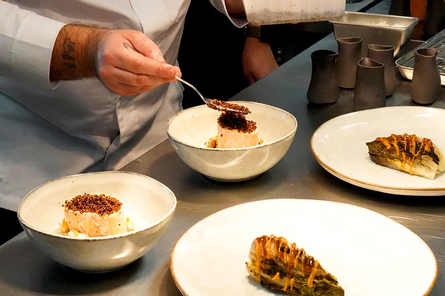 Chef at Restaurant Tòvera plating a gastronomic dish near Périgueux