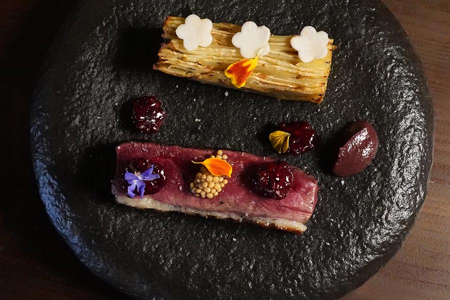 Duck breast and seasonal garnish served at Restaurant Tòvera near Périgueux